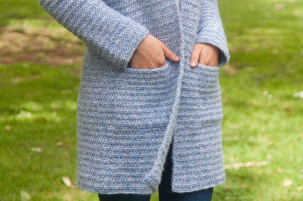 close up of hidden seamless crochet pockets in a cardigan coat