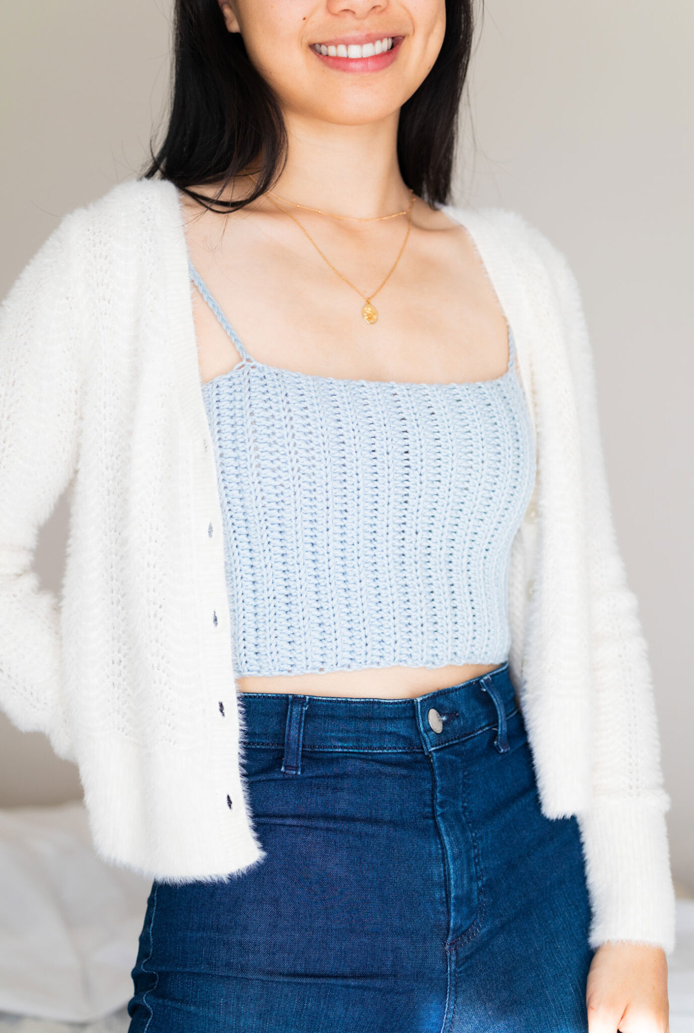 woman wearing baby blue crochet crop top with fuzzy white cardigan free pattern