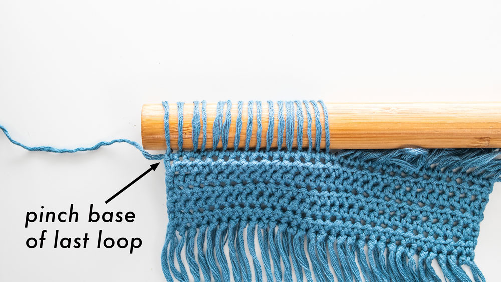 dowel full of crochet loops pinch the base of the last loop