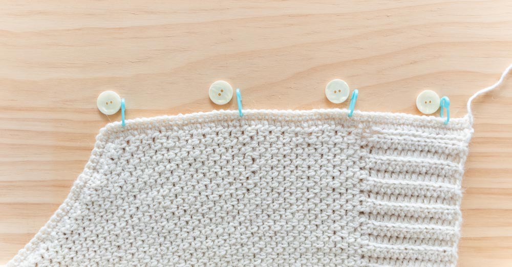 stitch markers placed in cardigan to mark button placement