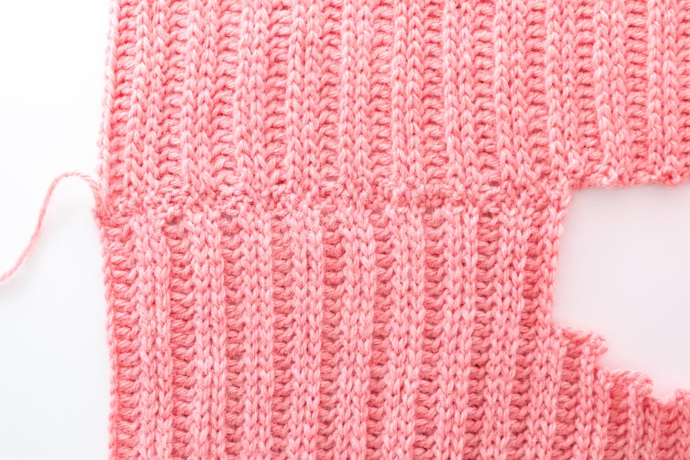 close up of sewn shoulder seams on ribbed sweater