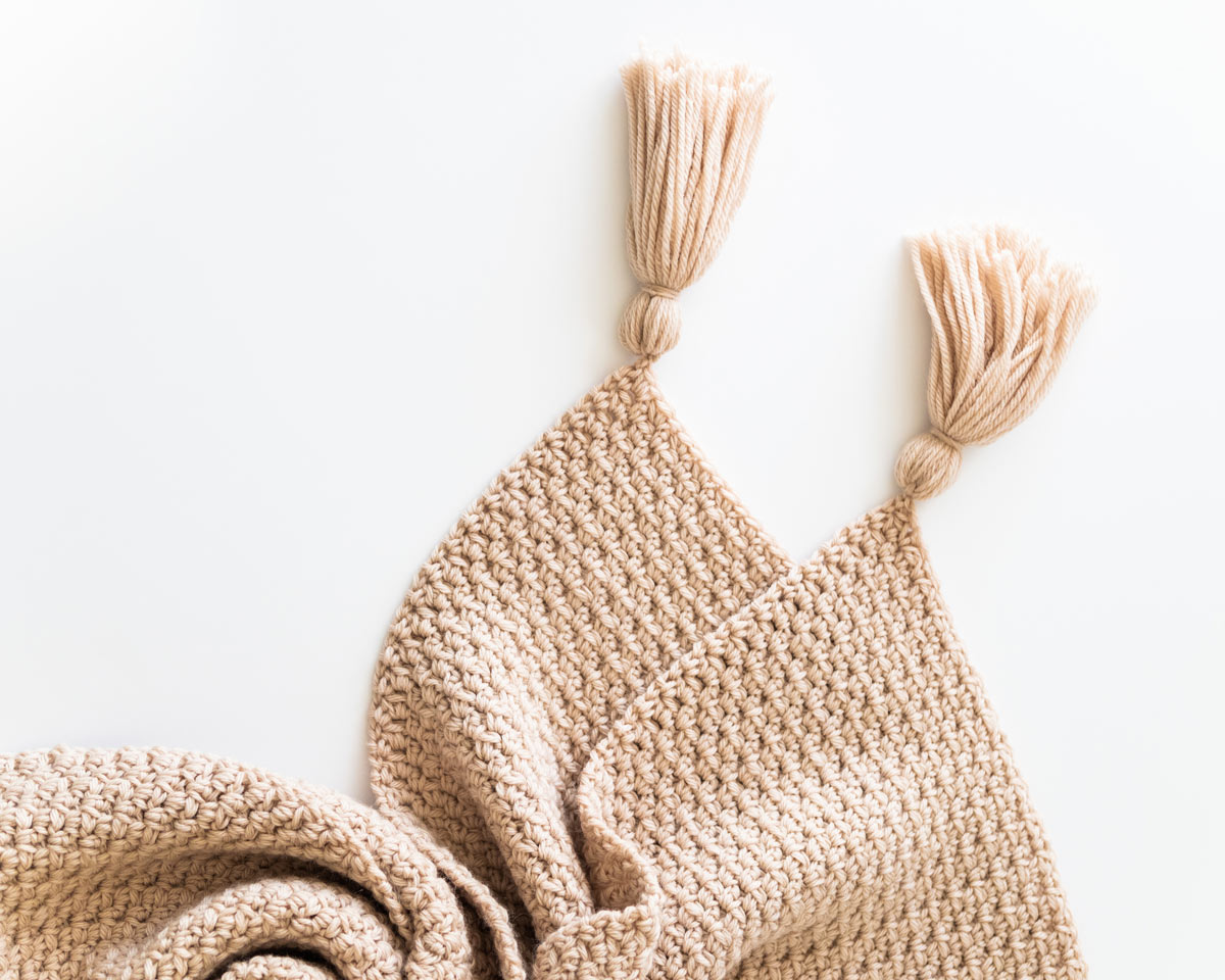 chunky textured crochet wool throw blanket with yarn tassels