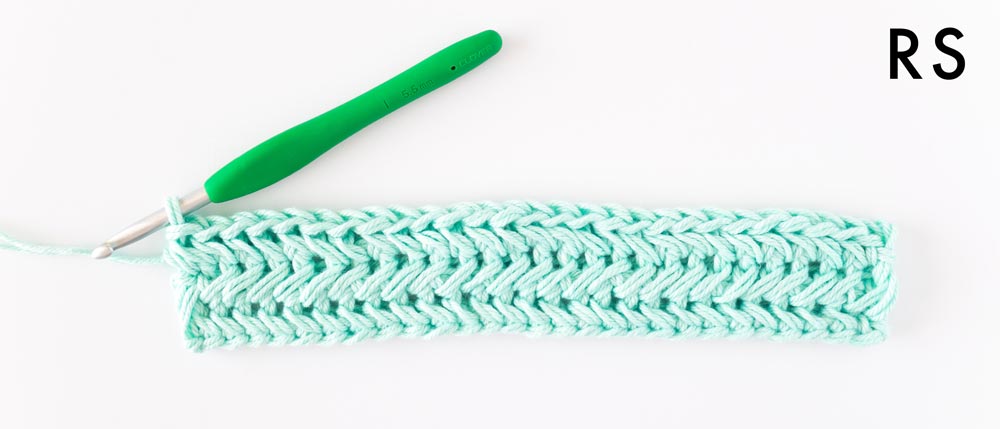 right side of row 3 of chevron single crochet stitch in mint cotton yarn