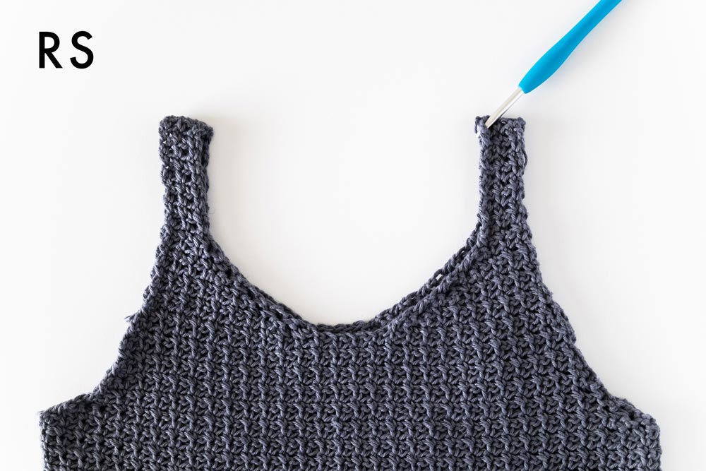crochet hook inserted along neckline of tank top