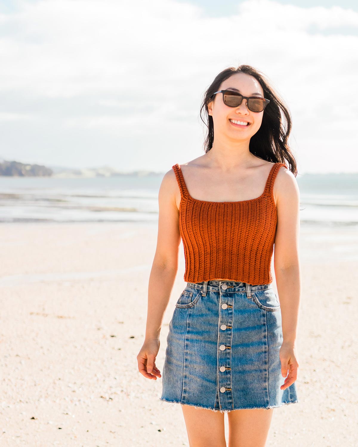 woman wearing summer crochet crop top with easy ribbing and denim high waisted button down skirt