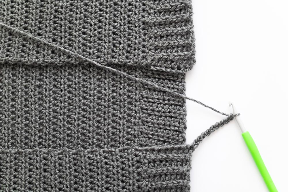 chain extended from corner of crochet cardigan front panel